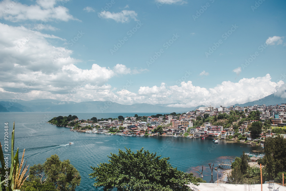 Water taxi boat pulls into the lakeside tourism town of San Pedro La Laguna, known as the party destination of Lake Atitlán, Guatemala Water taxi boat pulls into the lakeside tourism town of San Pedro La Laguna, known as the party destination of Lake Atitlán, Guatemala
