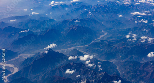 Mountains and blue sky. View out of an airplane window.