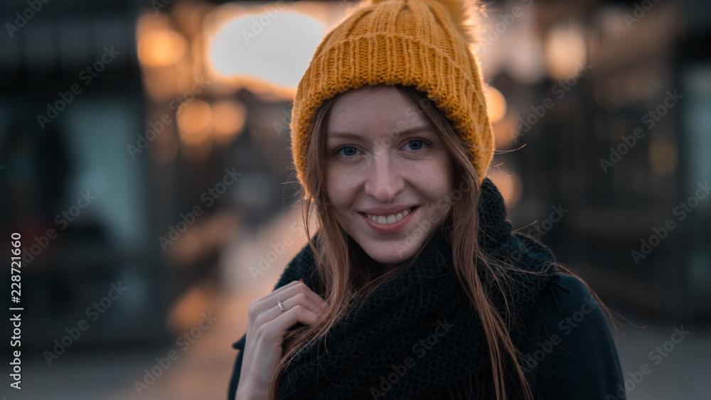 Sunset portrait of beautiful girl in Yellow Hat. Winded, Blur background.