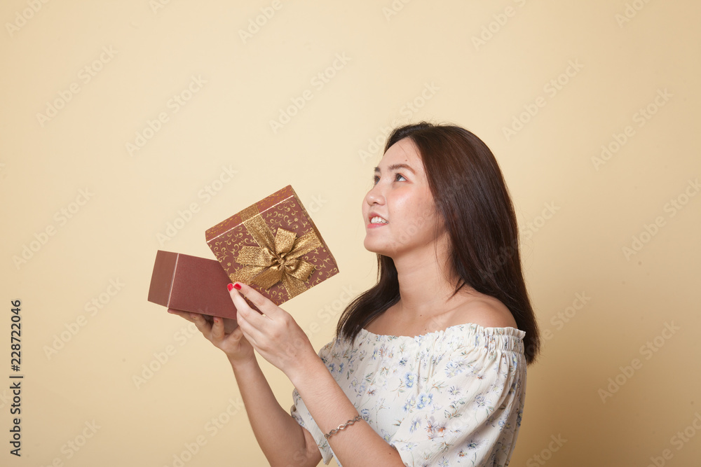 Young Asian woman open a gift box. Young Asian woman open a gift box.