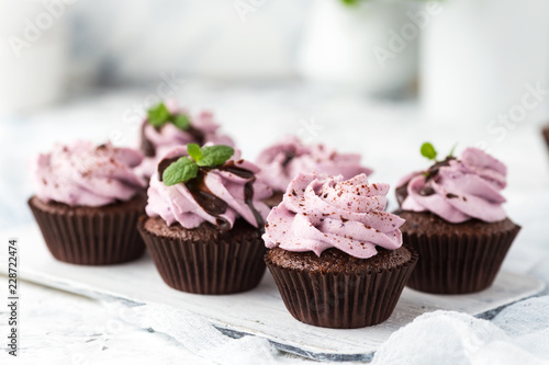 Cocoa cupcakes decorated berry cheese cream and chocolate