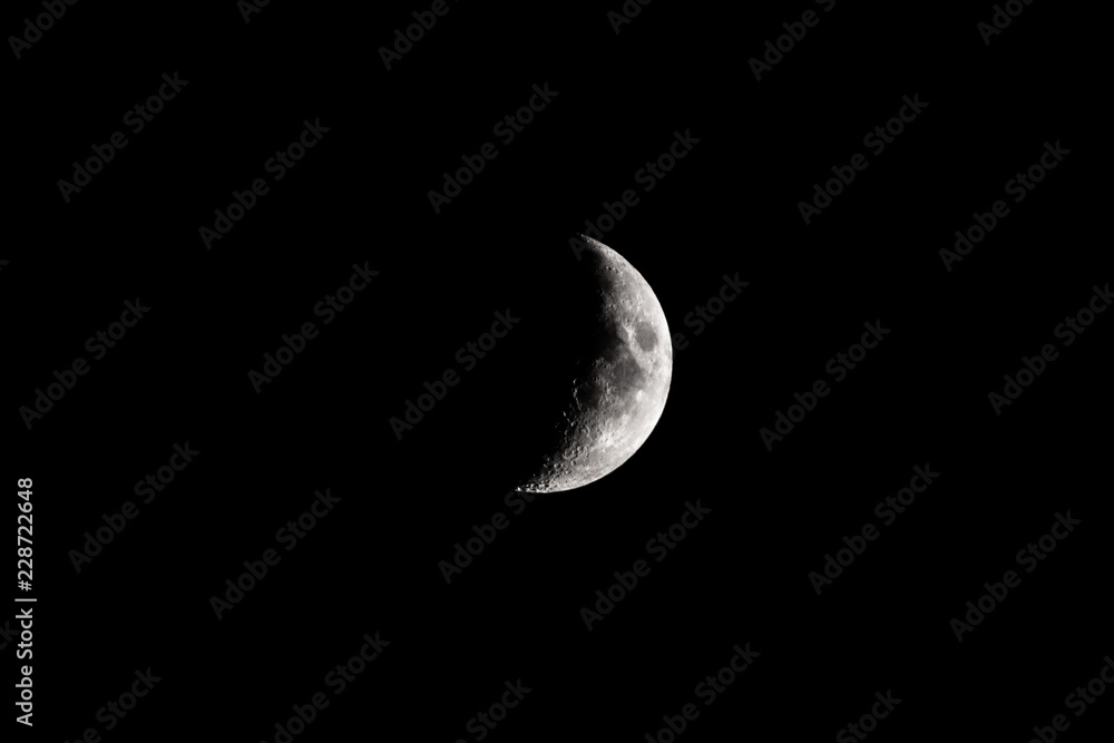 Partial Moon on Dark Night Sky with stars and isolated bright white moon at midnight Partial Moon on Dark Night Sky with stars and isolated bright white moon at midnight