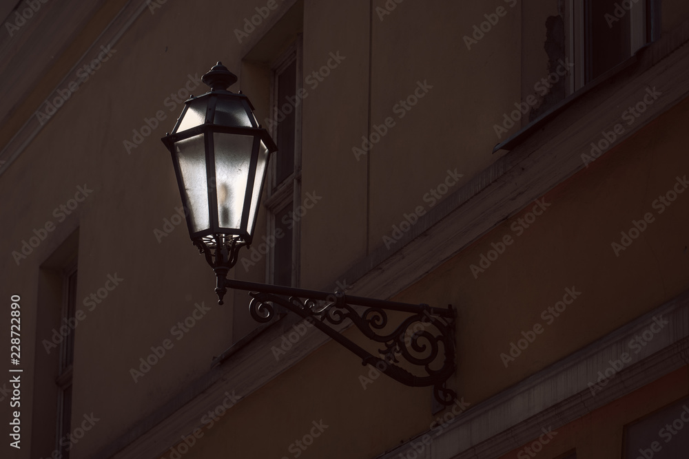 Old street lamp on the wall of Vilnius old town