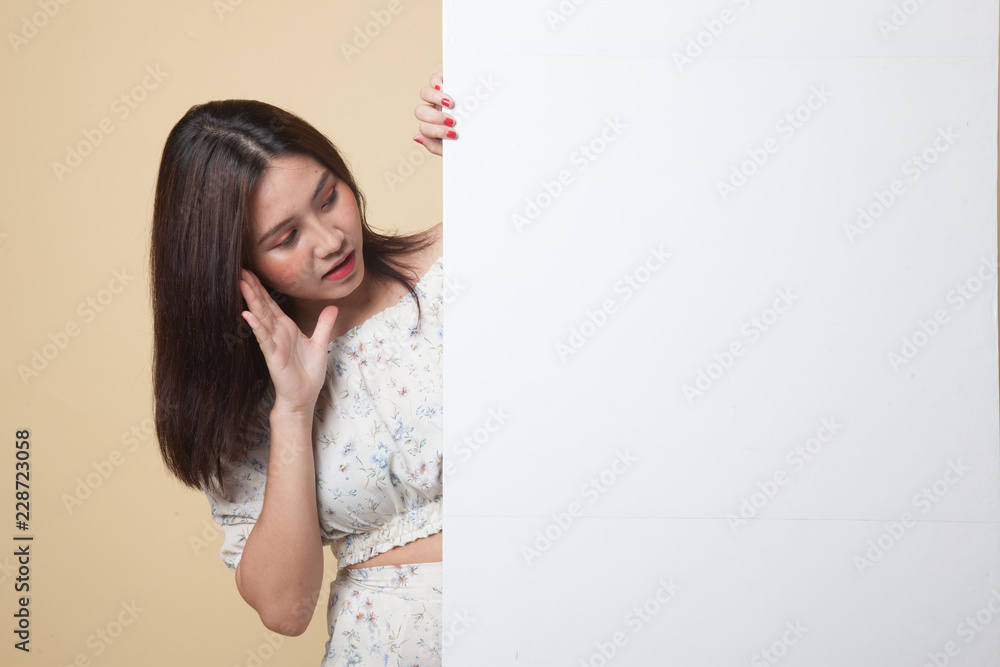Excited young Asian woman with blank sign.