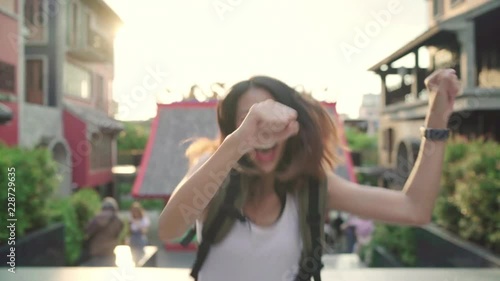 Wallpaper Mural Slow motion - Cheerful beautiful young Asian backpacker blogger woman feeling happy dancing on street while traveling at Chinatown in Beijing, China. Lifestyle backpack tourist travel holiday concept. Torontodigital.ca