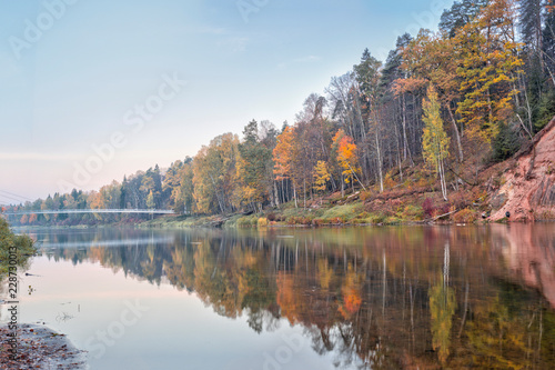 Autumn landscape and red stone cliff of Gauja river, Latvia, Europe. © juriskraulis