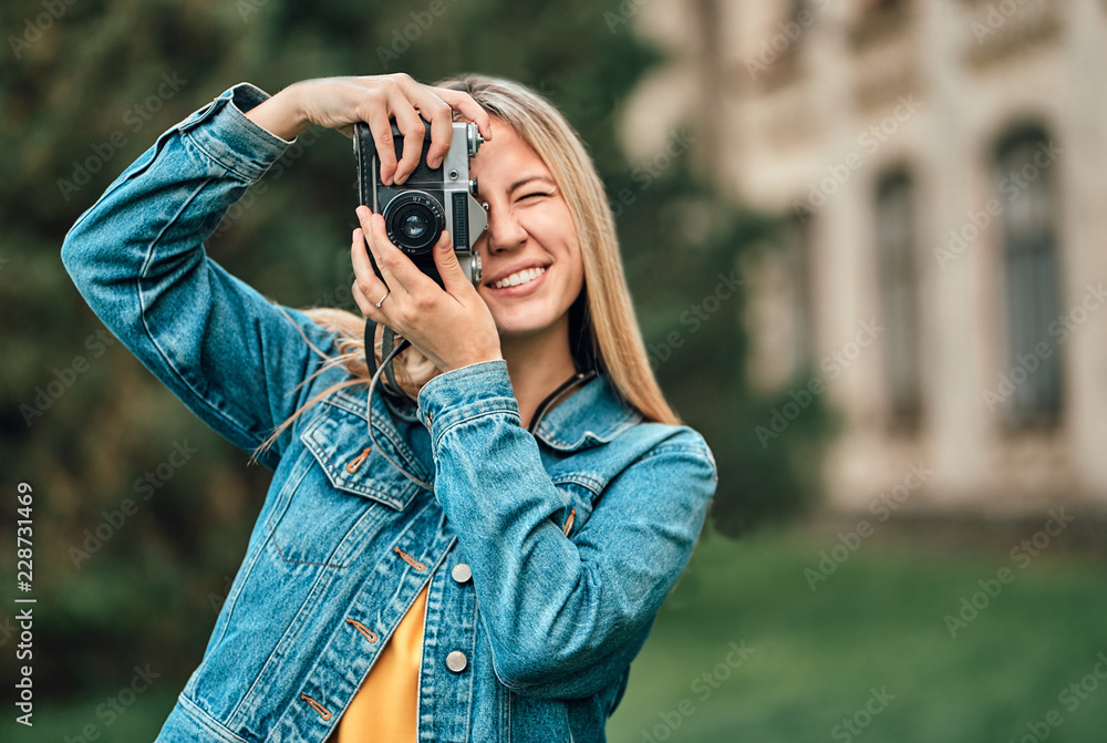 Girl taking pictures on a retro camera