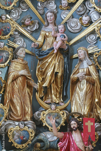 Our Lady Queen of the Rosary with St. Dominic and St. Clare on the altar in the Baroque Church of Our Lady of the Snow in Belec, Croatia  photo