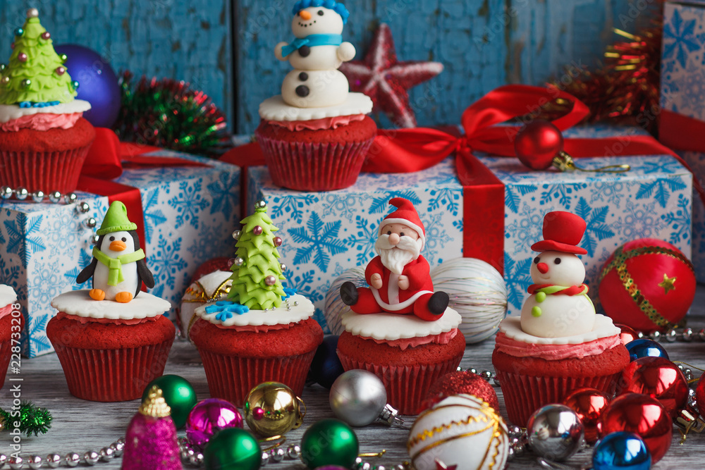 Christmas cupcakes with colored decorations, soft focus background