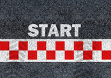 Start written with paint on road asphalt and race start line