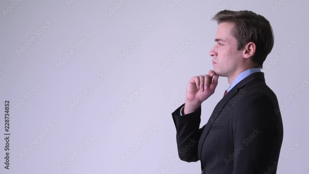 Profile view of young handsome businessman thinking Profile view of young handsome businessman thinking