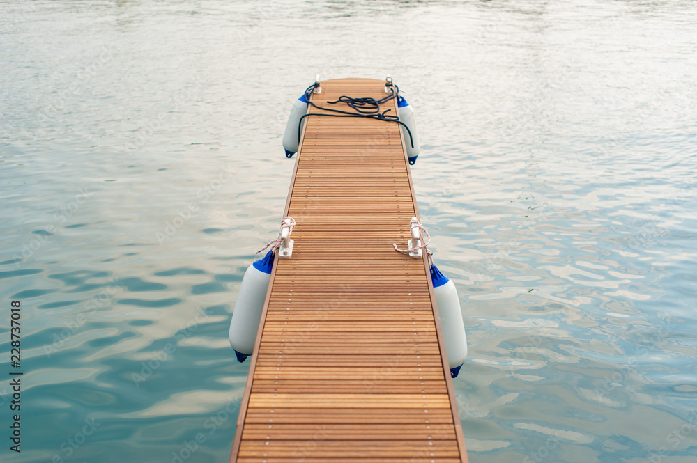 Obraz premium Wooden pier with buoys