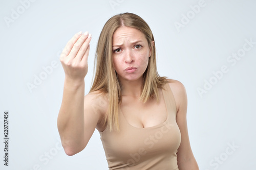 Wallpaper Mural Portrait of young woman doing a typical italian gesture, frowning and looking straight ahead Torontodigital.ca