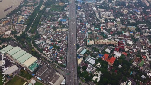 Cars driving on bridge roads with buildings. Aerial view of Expressway Bangna, Klong Toey in structure of architecture concept, Urban city, Bangkok, Thailand. photo