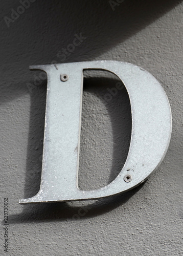 Letter D. On brown background