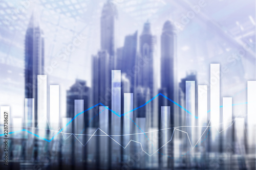 Financial graphs and charts on blurred business center background. Invesment and trading concept.