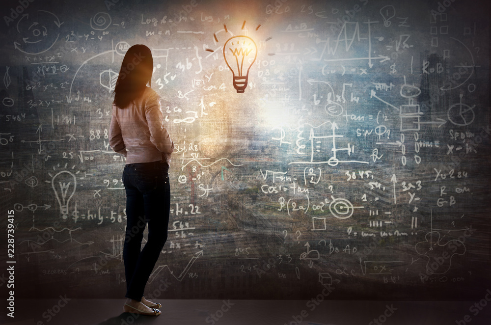 Young woman looking on the black board with mathematical formulas and calculations. Bright idea, way of thinking, discovery and challenge concept. Young woman looking on the black board with mathematical formulas and calculations. Bright idea, way of thinking, discovery and challenge concept.