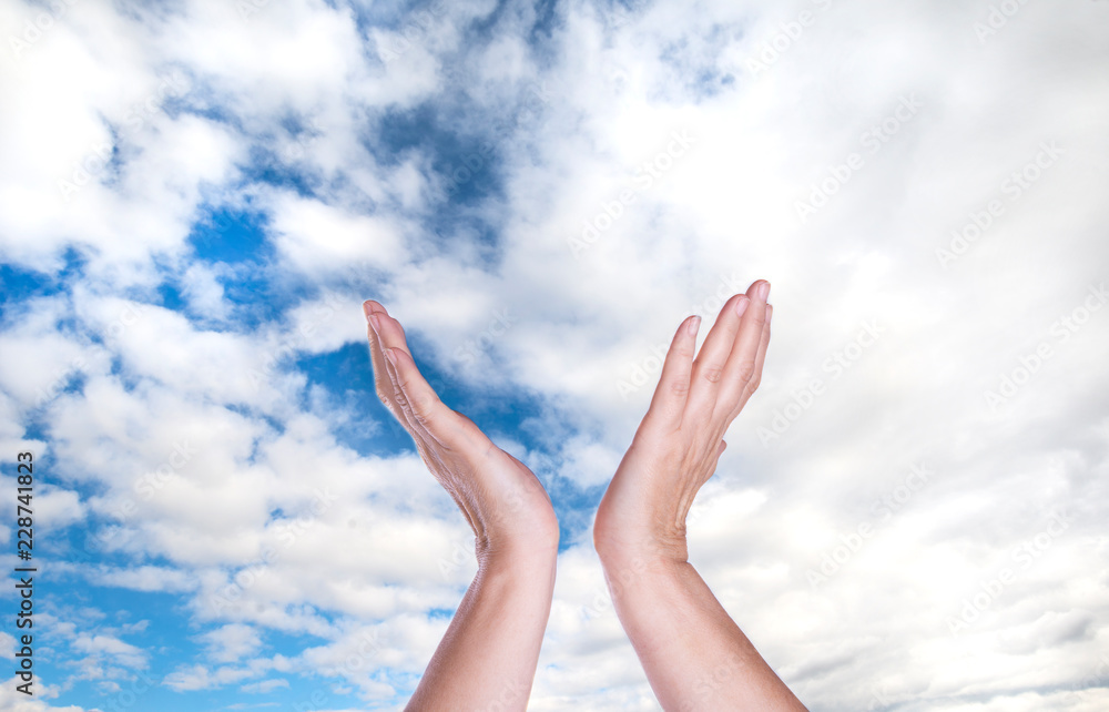 Healing hands in the sky with bright sunburst Healing hands in the sky with bright sunburst