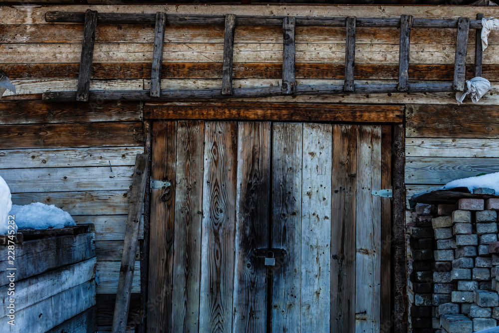 Dark wooden texture background. Old wooden door in winter