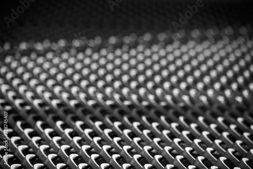 Monochrome metal grill surface with shadow