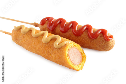 Corn dogs with ketchup and mustard isolated on white background 