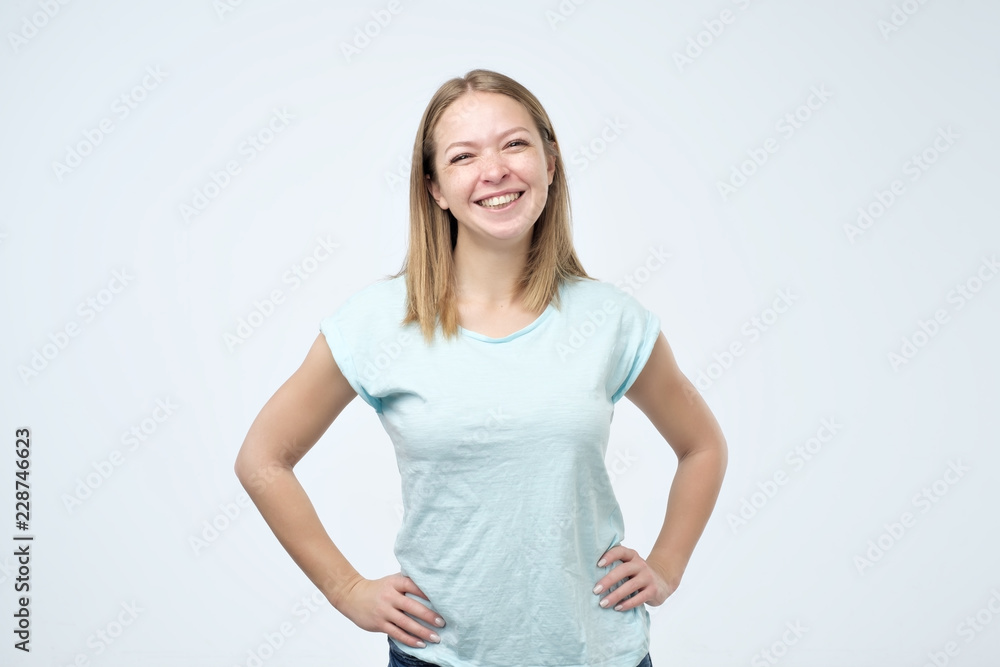 Beautiful girl with beautiful smile in studio looking at camera, portrait. Positive emotion Beautiful girl with beautiful smile in studio looking at camera, portrait. Positive emotion