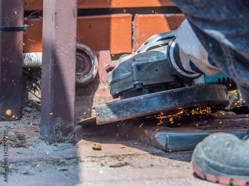 locksmith cuts the gate with a diax grinder photo