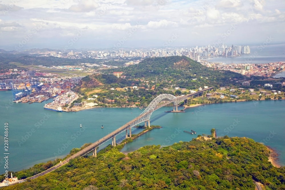 Aerial view of the Bridge of the Americas at the Pacific entrance to the Panama Canal with Panama City in the background.