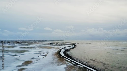 Slow Flight over frozen Sandgerdi, Iceland Golf Course and coast photo