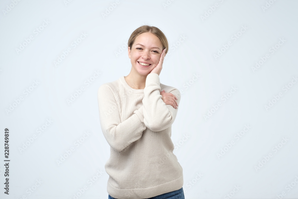 Beautiful girl with beautiful smile in studio looking at camera, portrait. Positive emotion Beautiful girl with beautiful smile in studio looking at camera, portrait. Positive emotion