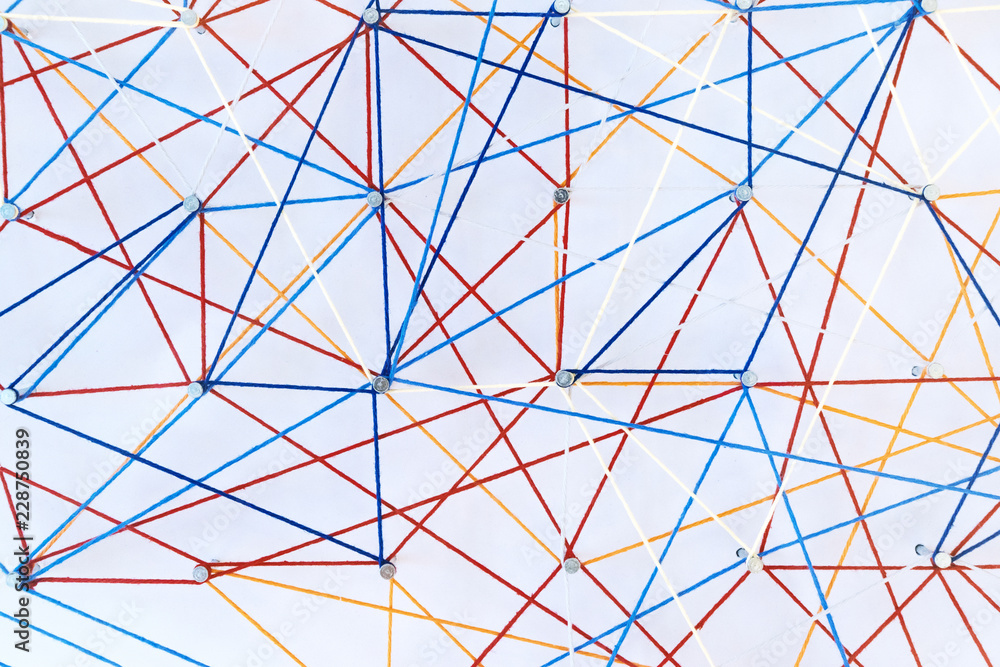 Fototapeta premium Abstract colored threads are stretched on pins on white background depicting ties and knots. Logistic grid, geometric, connections, isometrics and spirograph