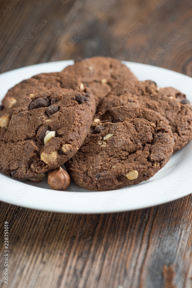 Soft dark chocolate brownie cookies on wood Soft dark chocolate brownie cookies on wood