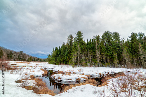 A river flows through the snow covered landscape