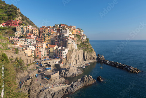 Colorful traditional houses on a rock over Mediterranean sea on dramatic sunset, Manarola, Cinque Terre, Italy © Konstantin Maslak