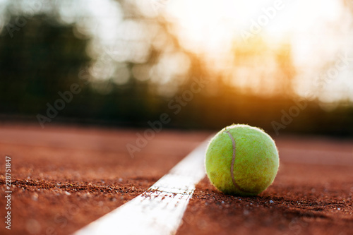 Tennis ball on clay court.  © kojala