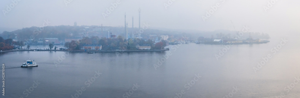 panorama view of boat cruising the harbor in stockholm in morning mist panorama view of boat cruising the harbor in stockholm in morning mist