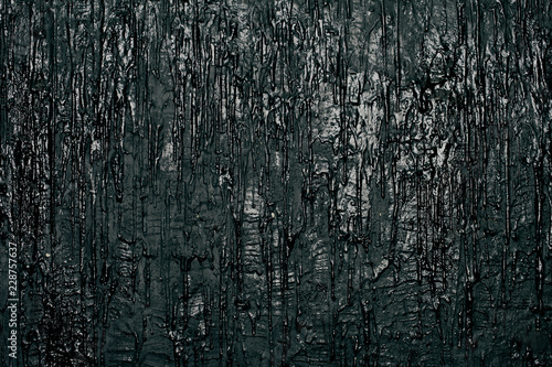 Wall with black flowing paint, art background