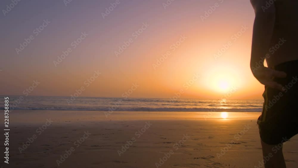 Silhouette of father with two children in the beach at sunset Silhouette of father with two children in the beach at sunset