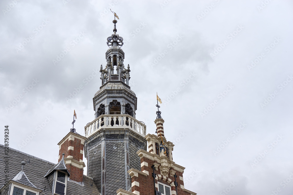 Tower of the old town hall of Franeker The Netherlands in renaissance style under a cloudy grey sky with copy space