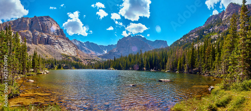 Photographer in Rocky Mountains The Noch lake with mountains panorama