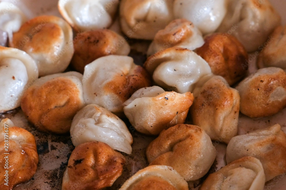 Dumplings frying on a pan. Close-up on table. Dumplings frying on a pan. Close-up on table.
