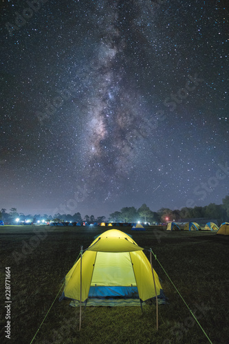 Night camping. Illuminated tourist tent under beautiful night sky full of stars and milky way