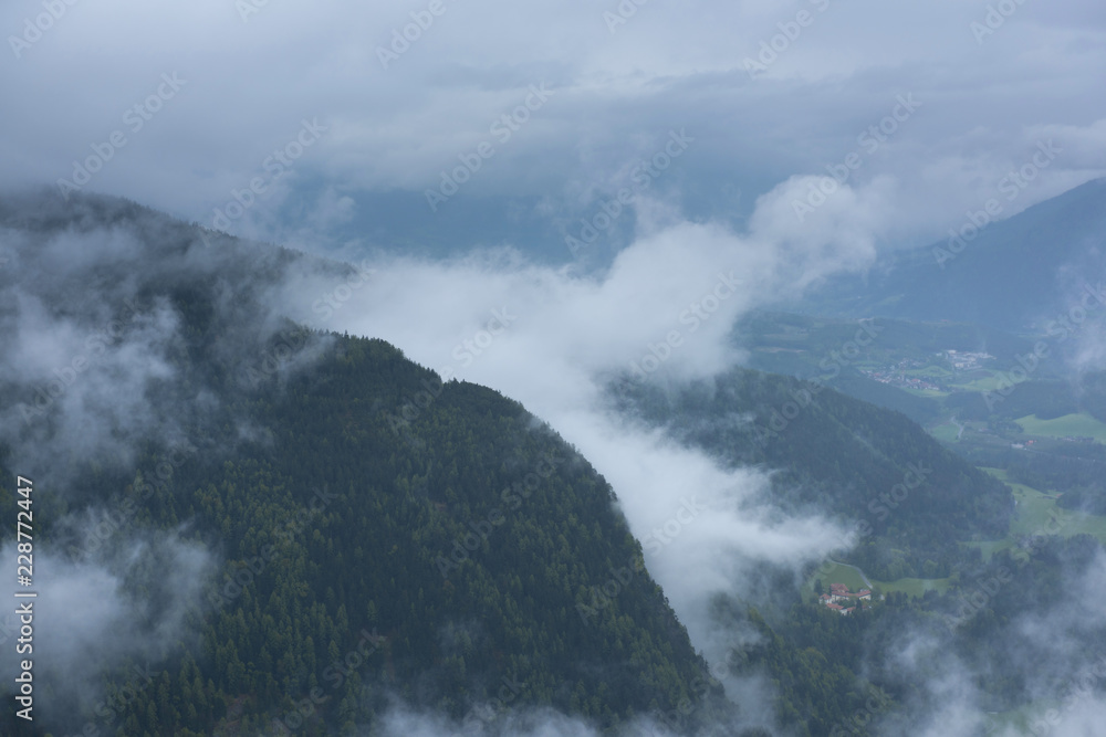 Hills of Dolomites, north Italy with low clouds during summer