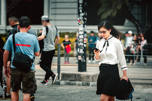 Business woman walking on crowded city street in Hong Kong
