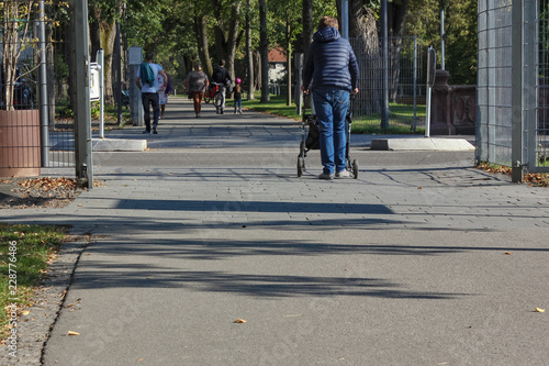lady walk with rollator in city park