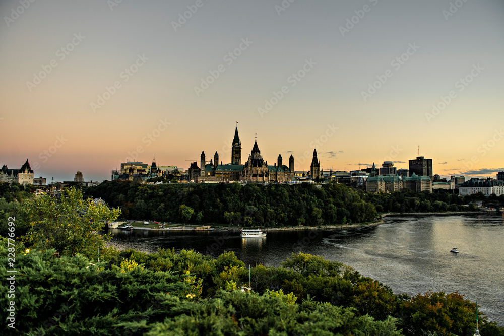 The Parliament of Canada and Ottawa River at the sunset The Parliament of Canada and Ottawa River at the sunset