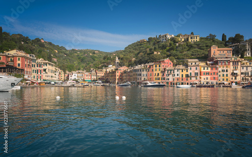 The beautiful Portofino panorama with colorfull houses, luxury boats and yacht in little bay harbor. Liguria, Italy