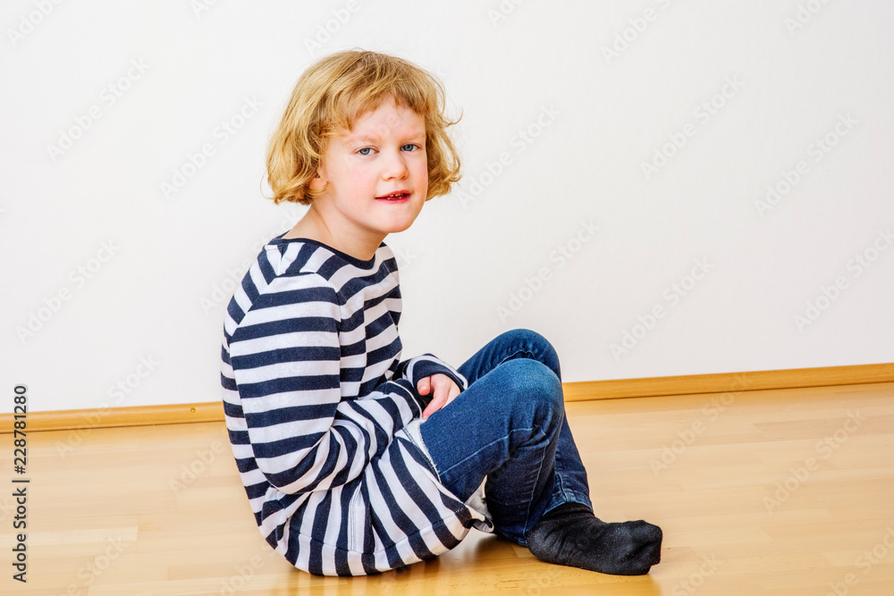 Child sitting on the floor Child sitting on the floor