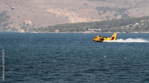 Firefighting aircraft refilling with water in the sea in Kefalonia, Greece photo