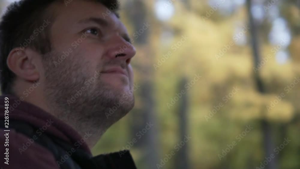 A man rides in the car on the autumn road. He enjoys the views and looks on the side. A man rides in the car on the autumn road. He enjoys the views and looks on the side.